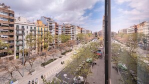 A view of a city street with multi-story buildings, trees, and parked cars. - Sweett | Roma 5B - One Bedroom Apartment, Sleeps 4 (Barcelona)