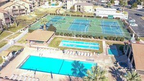 A tennis court complex with multiple courts, a swimming pool, and sun loungers. - Charming 2-bedroom condo with pools, courts and more in St. George (St. George)