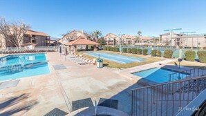 A hotel with multiple swimming pools, sun loungers, and a clear view of the surrounding buildings. - Charming 2-bedroom condo with pools, courts and more in St. George (St. George)