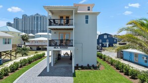 A two-story building with a balcony and a sign reading "SEA BOUND". - Sea Bound, Private Pool, Fire Pit, Multiple Decks, Hot Tub- 2 Blocks To Beach (Gulf Shores)