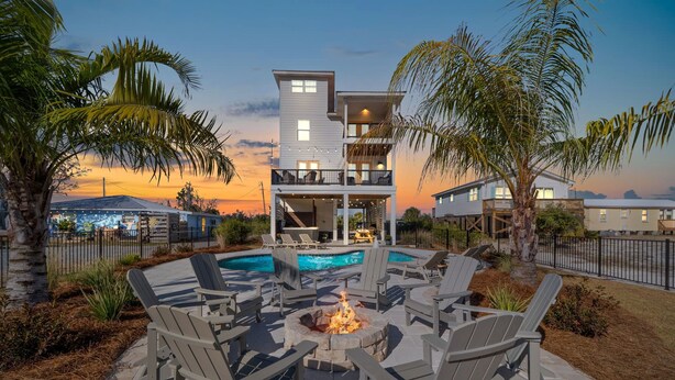 A two-story house with a pool, outdoor seating, and a fire pit. - Sea Bound, Private Pool, Fire Pit, Multiple Decks, Hot Tub- 2 Blocks To Beach (Gulf Shores)