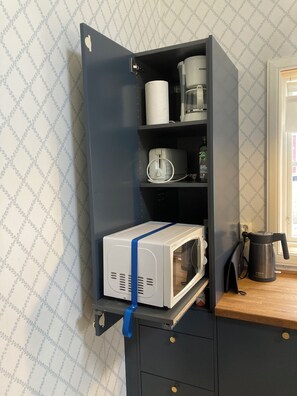 Enjoy a convenient kitchenette with a microwave, coffee maker, and kettle.