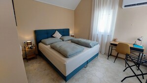 Une chambre à coucher avec un lit, un bureau et une chaise.