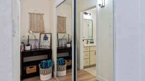 A bathroom with a mirror, a sink, and a toilet. - Remodeled Ground floor studio, AC, across from the beach, close to everything (Kihei)