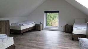 A bedroom with two beds, a wooden wardrobe, and a skylight. - Nice Apartment With Dishwasher, in a Residence 500 m. From the ski Lift (Winterberg)