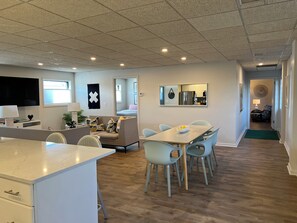Relax in this stylish living space with a dining area, comfortable sofa, and flat-screen TV.