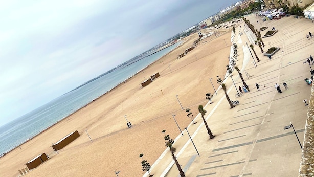 A beach with a wide promenade, palm trees, and a clear view of the sea. - Résidence Beach palace 1, apartment at the beach  (Mohammédia)
