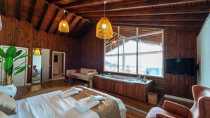 A spacious bedroom with a large bed, a sitting area, a bathtub, and a TV. - Trio Palazio Sapanca (Sapanca)