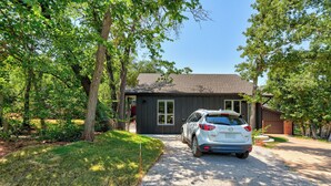 A modern house with a gravel driveway and a parked car. - New Guesthouse w/ Private Patio, Fast WiFi, 1 bed/1 bath (Edmond)