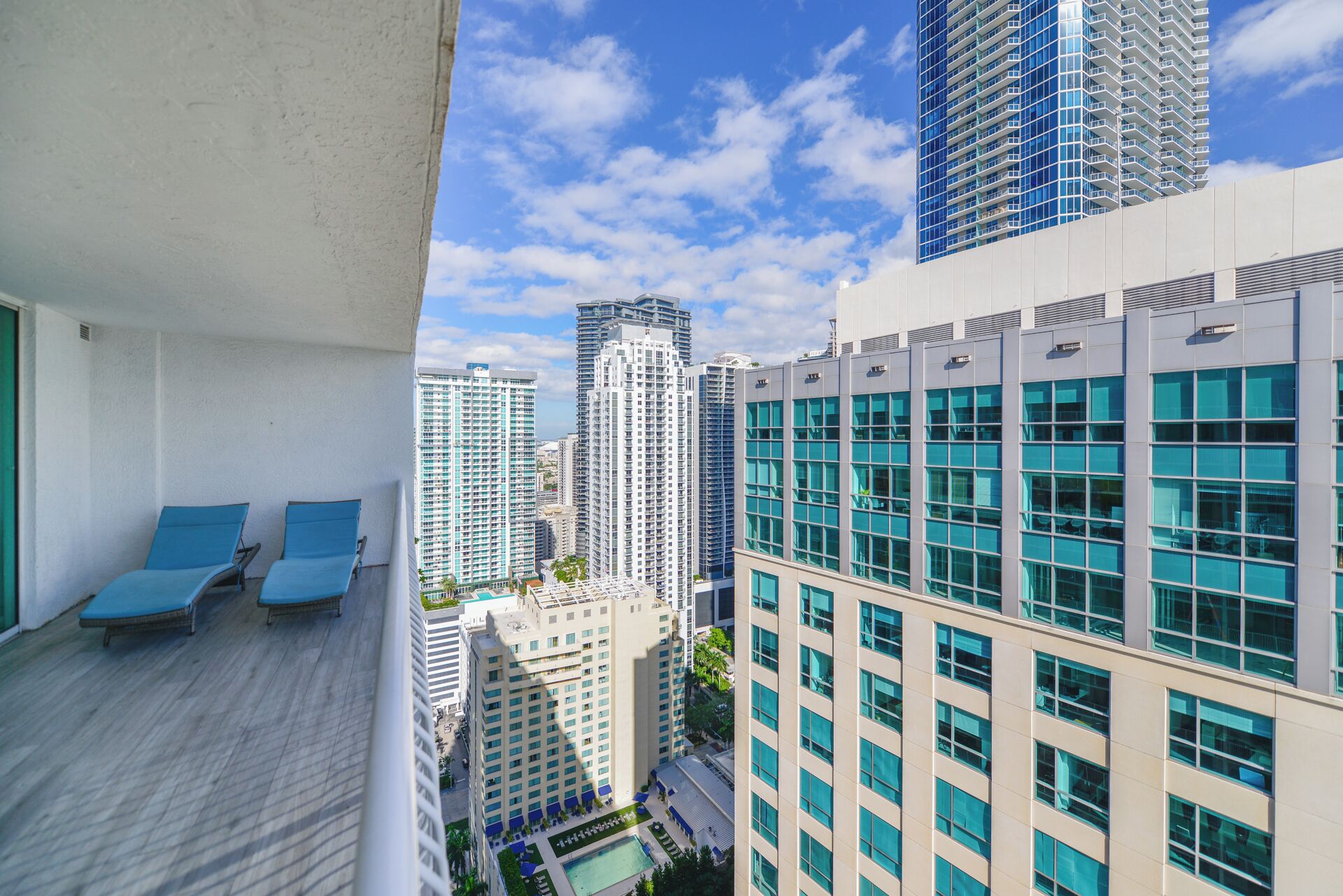 A high-rise building with multiple floors, large windows, and a clear sky.