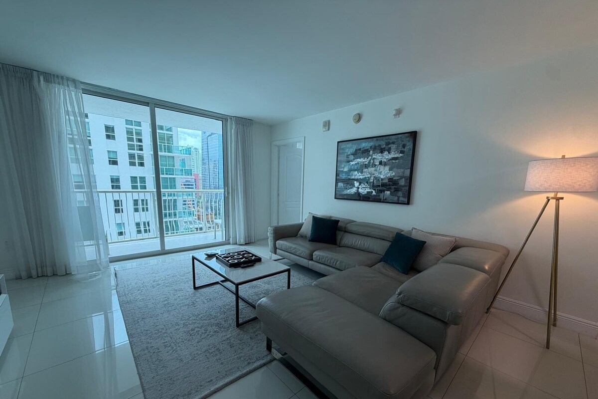 A modern living room with a sofa, a coffee table, and a floor lamp.