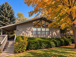 A single-story house with a covered porch, a front window, and a small staircase leading to the entrance.