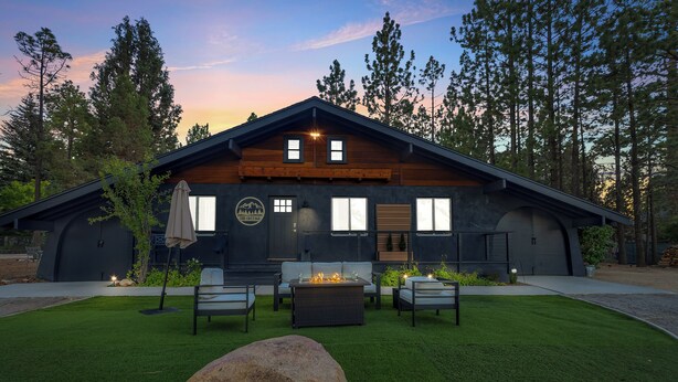 A modern log cabin with a stone fireplace, outdoor seating, and a well-maintained lawn. - THE Cottage #2504 (Big Bear City)