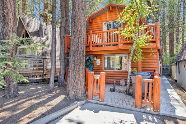 A log cabin with a balcony, surrounded by tall trees. - OUR Cabin IN THE Woods #2476 (Big Bear Lake)