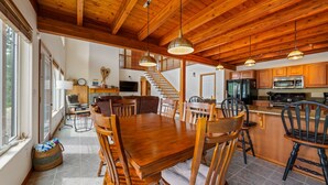 A spacious kitchen with wooden cabinets, a large island, and modern appliances.