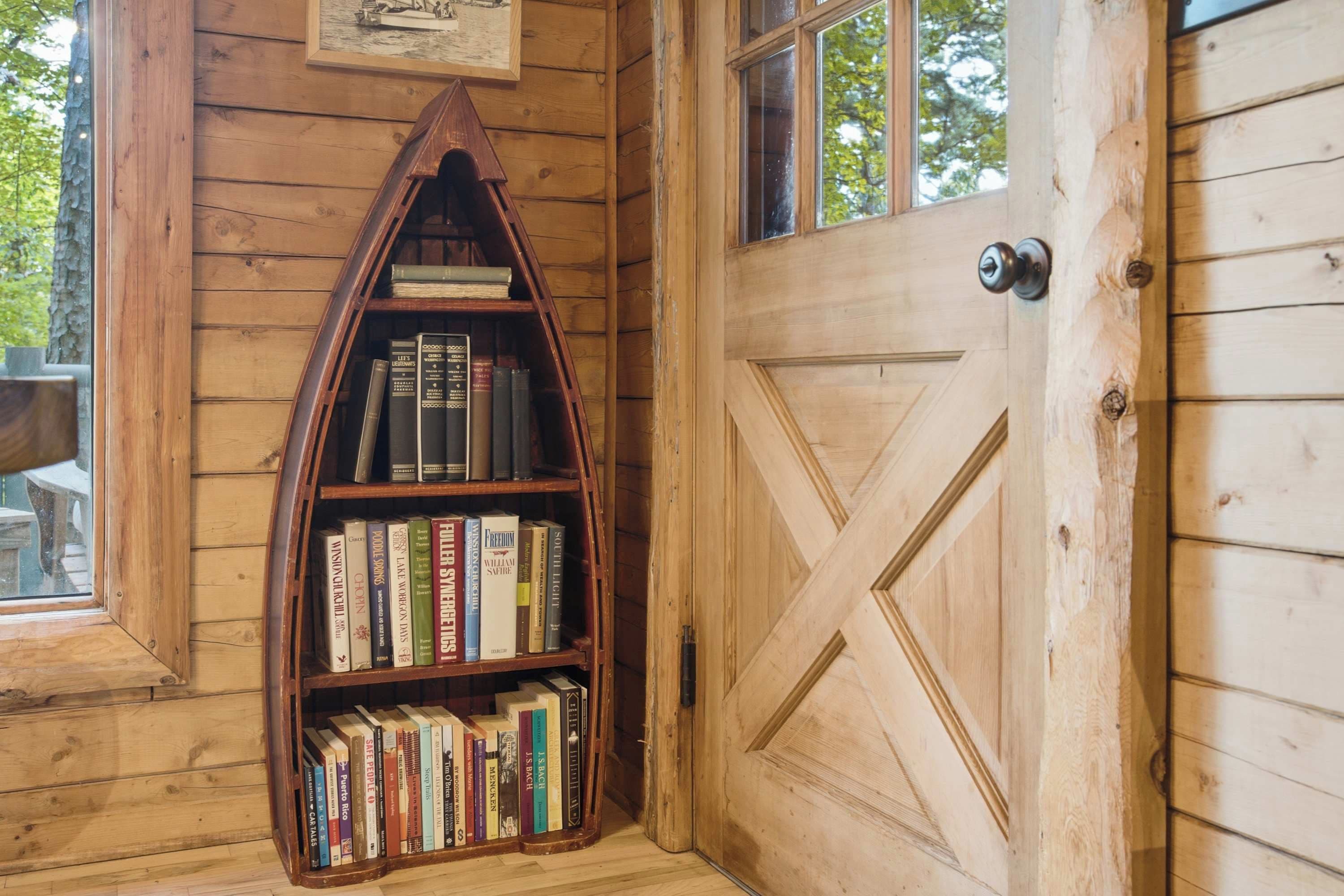 A wooden door with a geometric pattern and a bookshelf filled with books.
