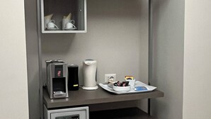 A compact kitchenette with a coffee maker, microwave, and mini-fridge. - Guest House Borgo Yporegia (Ivrea)