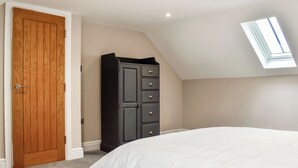 A bedroom with a bed, a wardrobe, a door, and a skylight. - UK47385 - The Deer Den (Easington, near Staithes)
