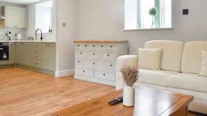 A modern living room with a sofa, a coffee table, and a white cabinet. - UK47385 - The Deer Den (Easington, near Staithes)