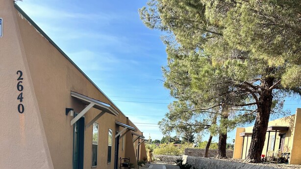 A pathway leading to a building with a number '2640' on the wall, surrounded by gravel and small plants. - Beautiful little Magnolia in Las Cruses  (Las Cruces)