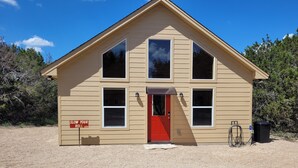 A two-story building with a red door and multiple windows. - Slow Your Roll - 2 King Suites • Near Bluff Dale Winery (Bluff Dale)