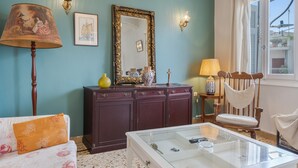 A room with a bed, a dresser, a chair, a lamp, a mirror, and a window. - Apartment 'Family, Enjoy Athens, Apt 90 Cm' with Private Garden, Wi-Fi and Air Conditioning (Athina)