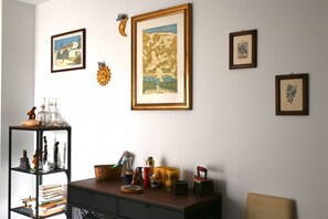 A room with a bookshelf, framed artwork, and a desk with various items. - N290 - Numana, three-room apartment with terrace overlooking the sea (Numana)