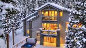 A two-story lodge with a balcony and a hot tub in the snow. - NEW The Hamilton Chalet: Private Hot Tub, Seclusion, & Incredible Mtn Views! (Breckenridge)