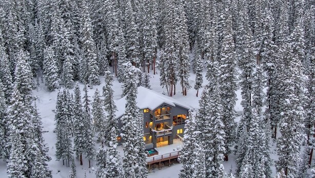 A snow-covered lodge surrounded by dense forest. - NEW The Hamilton Chalet: Private Hot Tub, Seclusion, & Incredible Mtn Views! (Breckenridge)