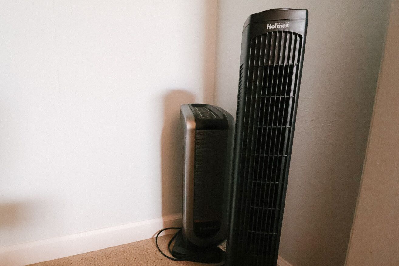 A black standing heater with the brand 'Holmes' visible on the top.