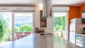 A kitchen with a large island, a microwave, and a refrigerator.