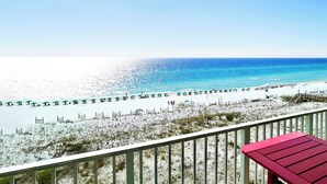 A beach view with a wooden deck and a red bench. - Gulf Dunes 507 • Amazing Direct Ocean View, 6th Floor Beach Condo, Tennis, Free Beach Service (Fort Walton Beach)