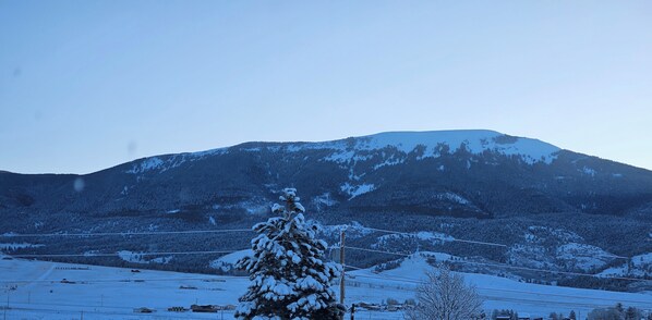 A snow-covered mountain landscape with a clear sky.