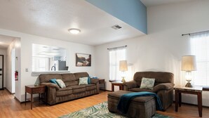 A living room with two couches, a coffee table, a rug, and a lamp. - New King Bed in spacious Ridge Manor Villa with BBQ, Screened Lanai, and Views (Ridge Manor)