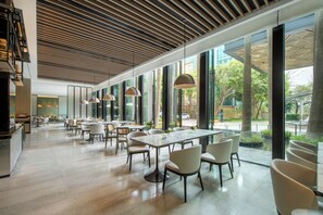 A spacious indoor area with large windows, modern furniture, and a wooden ceiling. - Seaview Gleetour Hotel Shenzhen (Shenzhen)