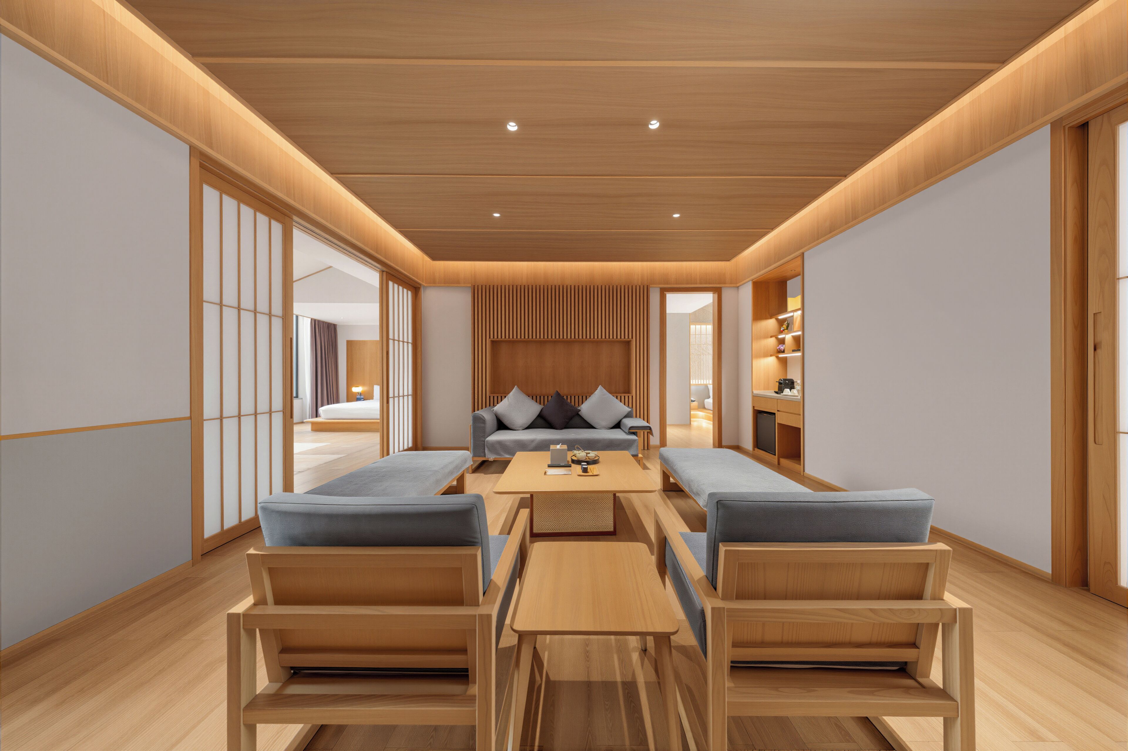 A modern interior with a sofa set, wooden tables, and a traditional sliding door.