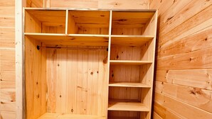 A wooden storage unit with multiple shelves and compartments.