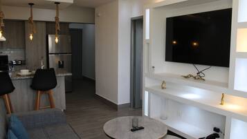 Deluxe Apartment | Living area | Flat-screen TV