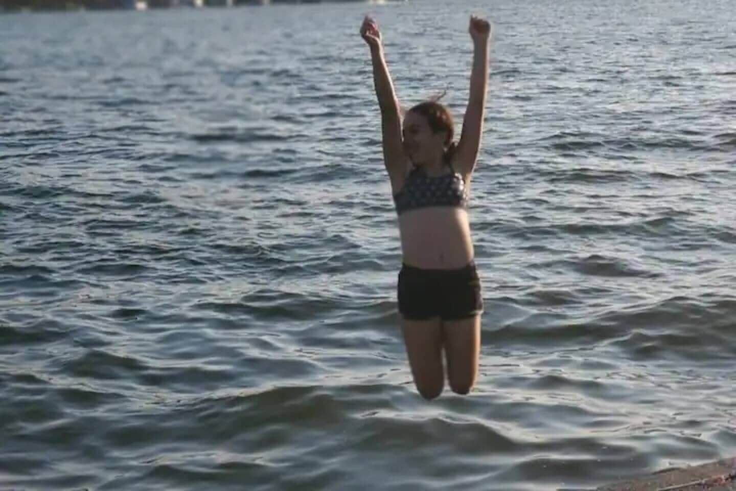 A person jumping into water.