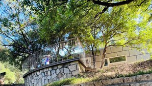 A stone staircase leading up to a balcony with a metal railing. - Private luxury — Minutes from City Center & airport (Austin)