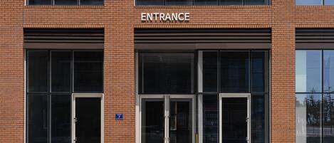A building entrance with a sign reading "ENTRANCE" above the doors.