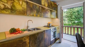 A modern kitchen with a large window, a sink, and a stove. - Studio Paradiso - Ski In Ski Out 300m, Sestriere, Italy (Sestriere)