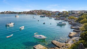 A coastal town with clear blue waters, numerous boats, and a rocky shoreline. - Gorgeous home in Sevid (Sevid)