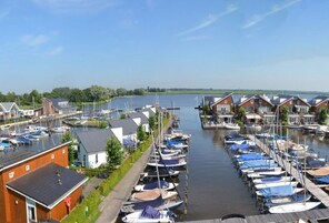 A marina with boats docked along a narrow waterway, surrounded by residential buildings.