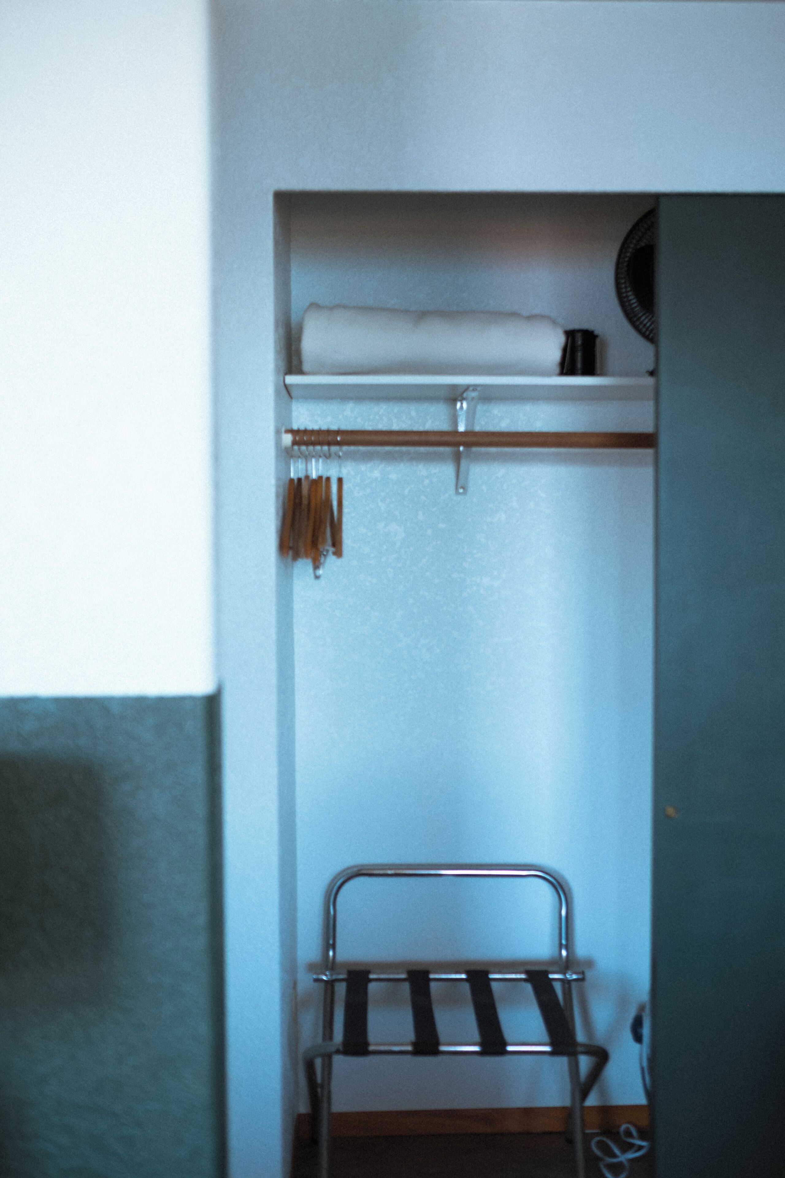 A bunk bed with a metal frame and a shelf above it.