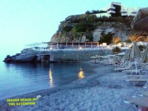 A coastal hotel with a rocky cliff, a beach with sun loungers, and a view of the sea. - LUXURIOUS COZY SEASIDE AP  ''MARIRENA 3'' (Mades)