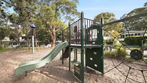 A playground with a slide, climbing structures, and a netted area. - Diamond Retreat by HolidayCo. (PEARL BEACH)