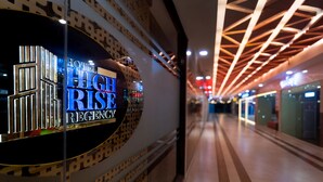 A hotel corridor with a prominent sign for 'HOTEL HIGH RISE REGENCY'.