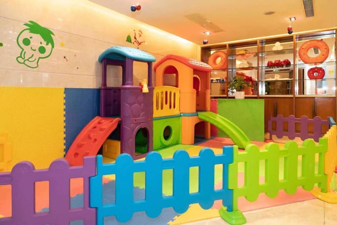 A children's play area with colorful play structures and a small slide.