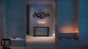A beautifully designed bathroom with a console table, mosaic tile wall, and a bench for added comfort.